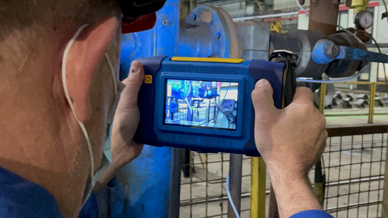 Technician using SonaVu acoustic imaging camera for compressed air leak detection